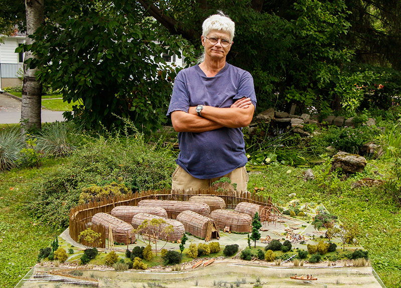 Michel Cadieux and his model of an Iroquoian village of the St. Lawrence circa 1450.